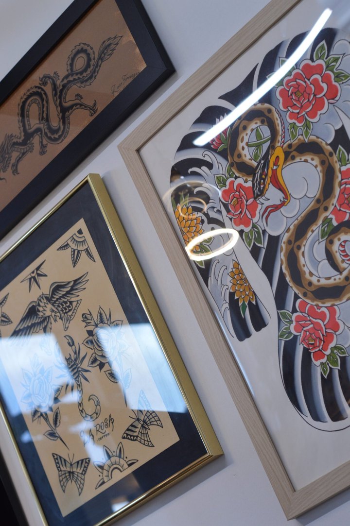 Flash detail: dragon signed Roco Fornazar beside a gold-framed La Rosa Tattoo sheet